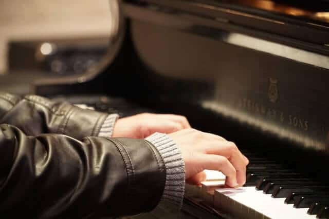 Man playing a steinway grand piano